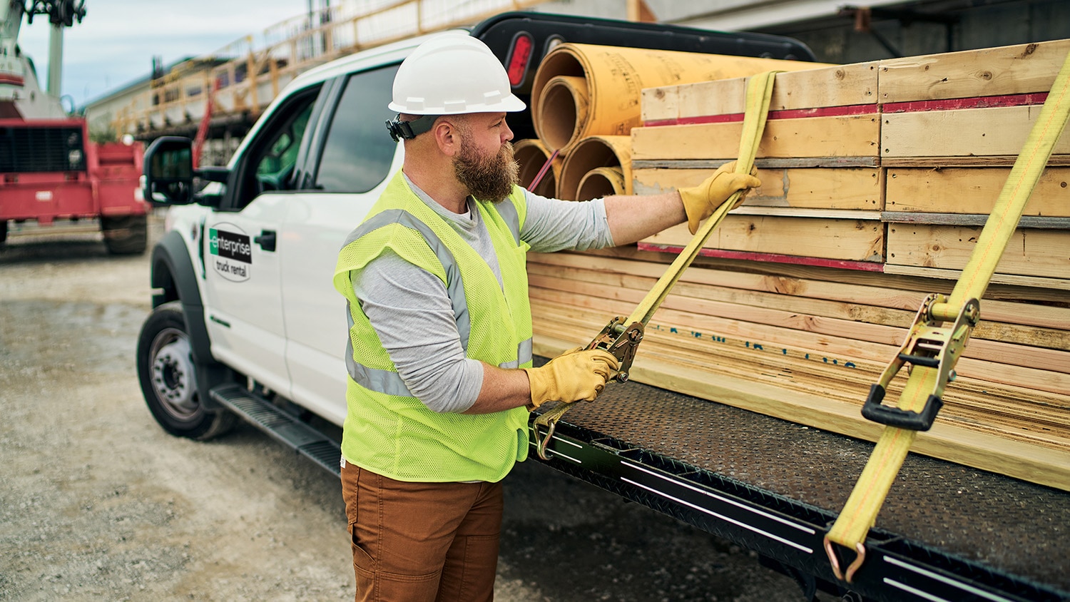 Person securing a load on a flatbed truck